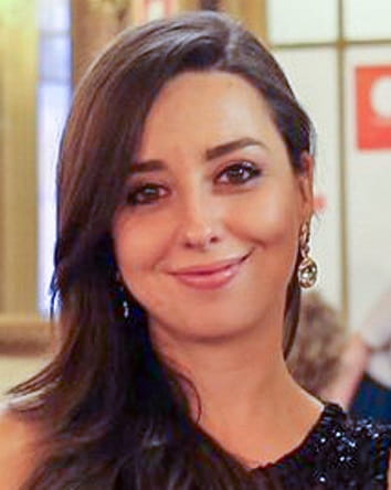 Headshot of Francisca Ferreira smiling to the camera with her hair swept to one side