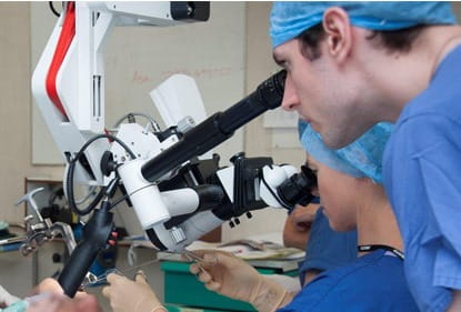 A surgeon using a microscope
