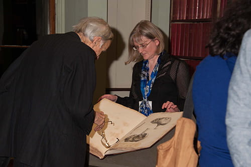 A visitor examining a book