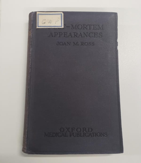 A dark grey book cover, inscribed 'Post-Mortem Appearances, Joan M. Ross, Oxford Medical Publications'