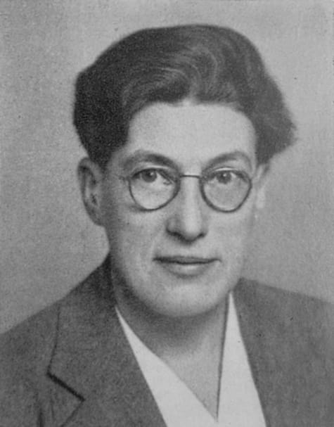 Photograph of a woman with short hair and round glasses