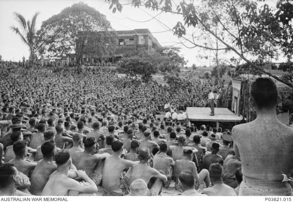 Juilian Taylor 5: A large crowd is entertained by an AIF concert party at Changi prisoner of war (POW) camp. This ...
