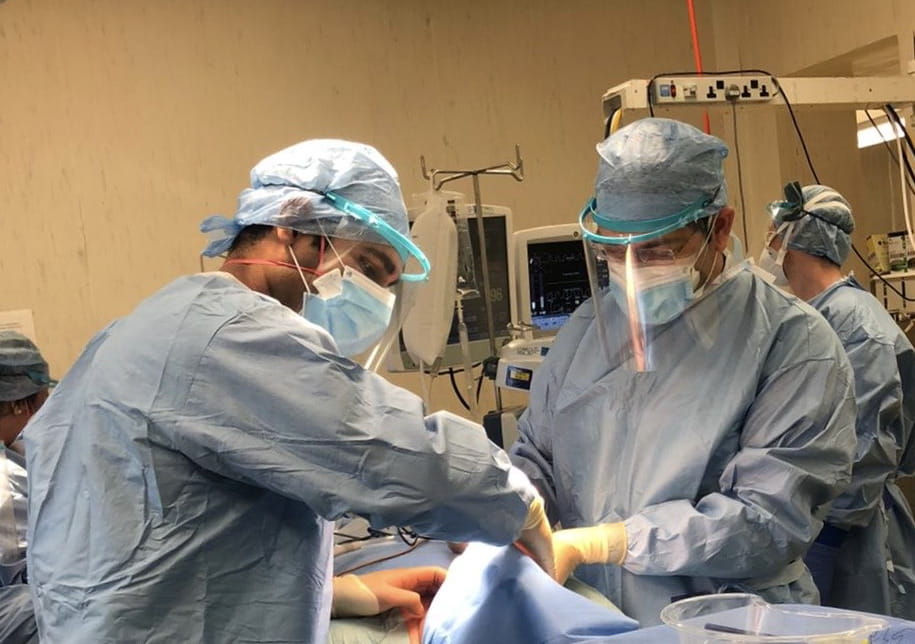 Rabindra Singh and colleague in operating theatre 